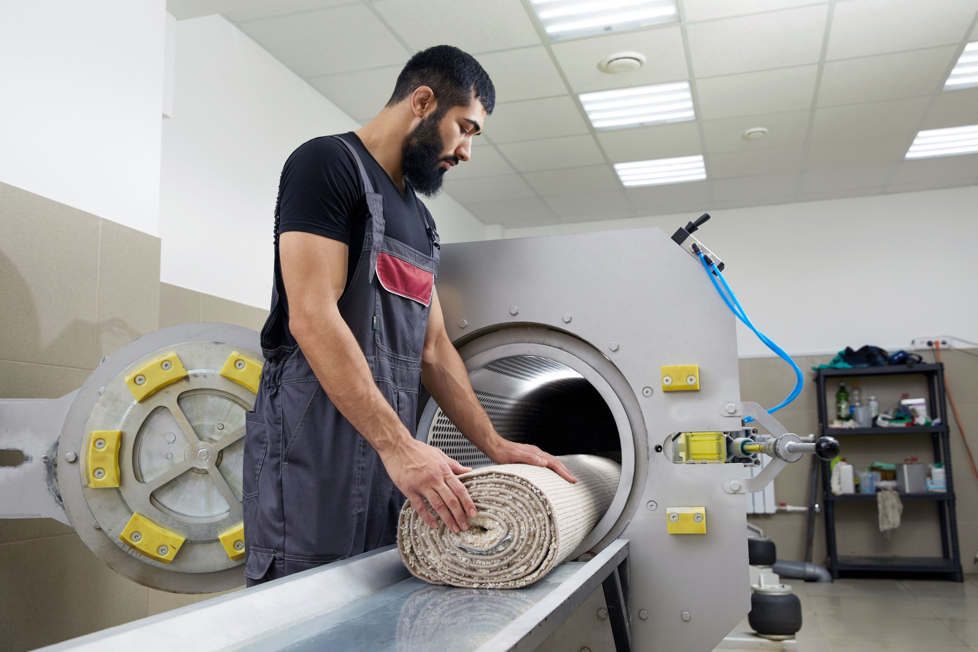 Man operating drying machine for carpet cleaning. Professional carpet cleaning service